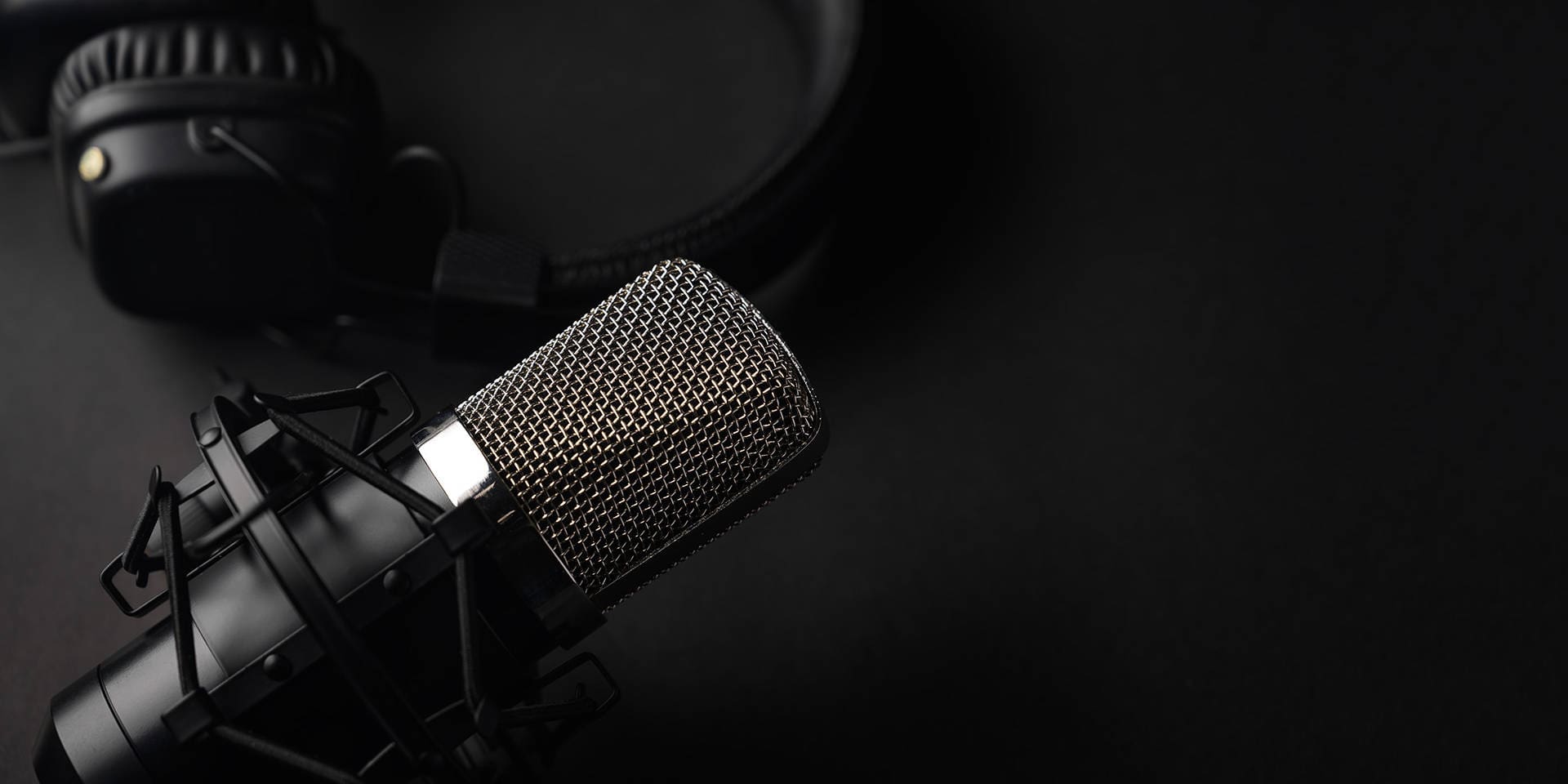 A microphone and headphones representing a podcast studio