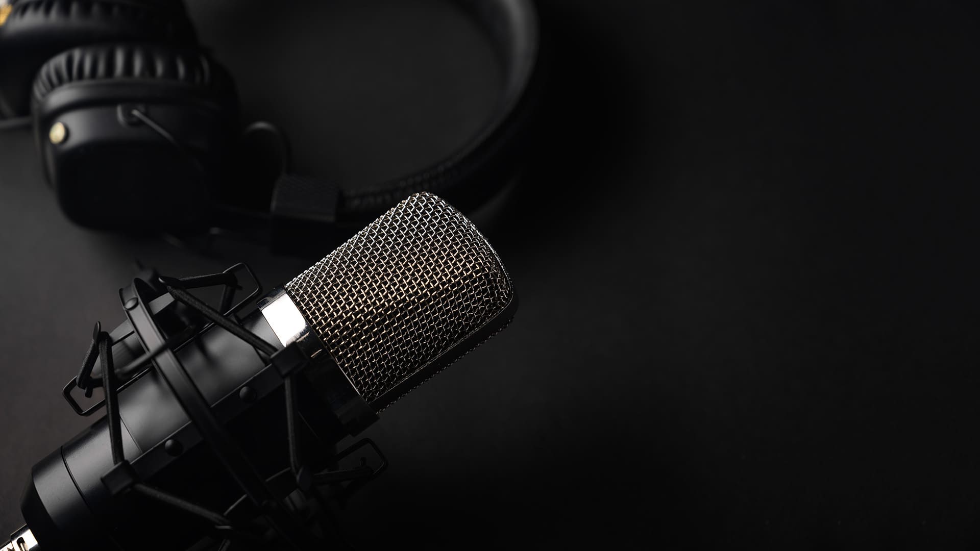 A microphone and headphones representing a podcast studio
